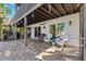 Outdoor patio features brick pavers, comfy seating and tropical-themed decor under the porch at 5241 West Shore Dr, New Port Richey, FL 34652