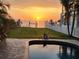 Stunning waterfront backyard with a pool and lush landscaping, perfect for outdoor living at 5241 West Shore Dr, New Port Richey, FL 34652