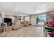 Basement area featuring tile flooring, comfortable seating, and sliding glass doors to the exterior at 5241 West Shore Dr, New Port Richey, FL 34652
