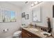 Well-lit bathroom with a granite countertop, stylish mirror, and framed pictures at 5241 West Shore Dr, New Port Richey, FL 34652