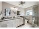 Elegant bathroom featuring double sinks, granite countertops, and a glass-enclosed shower at 5241 West Shore Dr, New Port Richey, FL 34652