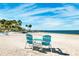 Relax on the serene beach with Adirondack chairs and scenic waterfront views at 5241 West Shore Dr, New Port Richey, FL 34652