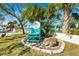 A charming turquoise beach chair and sign invite you to the private beach club at 5241 West Shore Dr, New Port Richey, FL 34652