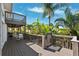 Multi-level deck surrounded by tropical foliage with a peek at the inground pool at 5241 West Shore Dr, New Port Richey, FL 34652