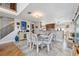 Dining area featuring a table with seating for six adjacent to an open kitchen with stainless steel appliances at 5241 West Shore Dr, New Port Richey, FL 34652