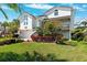 Charming two-story home with landscaped yard and a paved driveway at 5241 West Shore Dr, New Port Richey, FL 34652