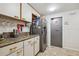 Well lit kitchen with updated stainless steel refrigerator and marble countertops at 5241 West Shore Dr, New Port Richey, FL 34652