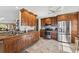 Well-lit kitchen featuring granite countertops, stainless steel appliances, and ample cabinet space for storage at 5241 West Shore Dr, New Port Richey, FL 34652