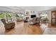 Bright living room with vaulted ceilings, fireplace, and natural light from large windows offering a cozy and inviting space at 5241 West Shore Dr, New Port Richey, FL 34652