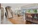 Inviting living room featuring hardwood floors, lots of natural light, and staircase to the upper level at 5241 West Shore Dr, New Port Richey, FL 34652