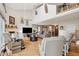 Open living room with high ceilings, fireplace, hardwood floors, and comfortable seating creating an ideal space for relaxation at 5241 West Shore Dr, New Port Richey, FL 34652