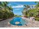 Beautiful pool and patio surrounded by tropical landscaping and views of the ocean at 5241 West Shore Dr, New Port Richey, FL 34652