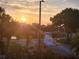 An overview of the neighborhood street with a decorative traffic island at sunset at 5241 West Shore Dr, New Port Richey, FL 34652