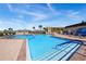 Community pool area with lounge chairs, pool house, palm trees, umbrellas and blue skies at 580 Boca Ciega Point S Blvd, St Petersburg, FL 33708