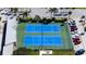 Aerial view of community tennis courts surrounded by lush landscaping and parking at 580 Boca Ciega Point S Blvd, St Petersburg, FL 33708