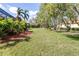 A spacious backyard lined with mature trees and meticulous landscaping enhances the property's appeal at 6209 Cypress Bend Ct, Bradenton, FL 34201