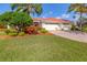 Beautiful single-story home with a well-manicured lawn, mature trees, and a brick driveway at 6209 Cypress Bend Ct, Bradenton, FL 34201