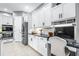 Bright kitchen with white cabinets, stainless steel appliances, and dedicated desk space at 6209 Cypress Bend Ct, Bradenton, FL 34201