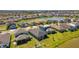 An aerial view showcasing a residential community with water views, lush greenery, and well-kept homes at 7096 Heron Walk Ln, Wesley Chapel, FL 33545