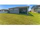 Well-maintained backyard with lush green lawn and a screened lanai for outdoor relaxation and enjoyment at 7096 Heron Walk Ln, Wesley Chapel, FL 33545