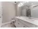 Bright bathroom featuring a double vanity with white cabinets and modern fixtures at 7096 Heron Walk Ln, Wesley Chapel, FL 33545