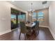Dining room with modern lighting, a table with seating for six, and a sliding glass door at 7096 Heron Walk Ln, Wesley Chapel, FL 33545