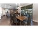 Open-concept dining area with modern chandelier, wood table and chairs, and sliding glass doors to patio at 7096 Heron Walk Ln, Wesley Chapel, FL 33545