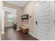 Entryway featuring dark wood-look flooring, storage, and a white door at 7096 Heron Walk Ln, Wesley Chapel, FL 33545