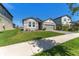 Attractive single-story home with a manicured lawn, stone accents, and a convenient two-car garage at 7096 Heron Walk Ln, Wesley Chapel, FL 33545