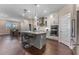Spacious kitchen with island, stainless appliances, pendant lights, and views to the dining area at 7096 Heron Walk Ln, Wesley Chapel, FL 33545