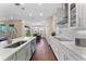 Bright kitchen features white cabinetry, modern appliances, and a view into the dining area at 7096 Heron Walk Ln, Wesley Chapel, FL 33545