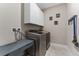 Laundry room featuring cabinets, laundry machines, and tile flooring at 7096 Heron Walk Ln, Wesley Chapel, FL 33545