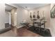 The living room features hard wood flooring, instrument display, with adjacent bathroom at 7096 Heron Walk Ln, Wesley Chapel, FL 33545
