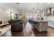Spacious living area with a large leather sofa, kitchen island, and dining area at 7096 Heron Walk Ln, Wesley Chapel, FL 33545