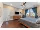Comfortable bedroom with a ceiling fan, sleek furniture, and a large window for natural light at 7096 Heron Walk Ln, Wesley Chapel, FL 33545