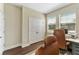 Well-lit office with built-in desk and cabinets, and a double-door entrance at 7096 Heron Walk Ln, Wesley Chapel, FL 33545