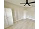 Neutral bedroom featuring wood-look flooring, a ceiling fan, and two large wardrobes at 7900 Hardwick Dr # 813, New Port Richey, FL 34653