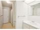Clean, white bathroom featuring a single sink vanity, tile flooring and full tub/shower at 8001 Jasmine Dr # 8001, Temple Terrace, FL 33637