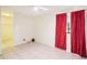 Bedroom with tile floor, ceiling fan, closet, and window with red curtains at 8001 Jasmine Dr # 8001, Temple Terrace, FL 33637