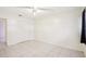 Clean bedroom features include tile floor, ceiling fan, closet and a window with black curtain at 8001 Jasmine Dr # 8001, Temple Terrace, FL 33637