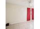 Neutral bedroom with tiled floor, featuring a ceiling fan and a window with red curtains at 8001 Jasmine Dr # 8001, Temple Terrace, FL 33637