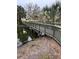 Exterior shot of a wooden bridge over a community pond surrounded by trees at 8001 Jasmine Dr # 8001, Temple Terrace, FL 33637