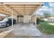 Covered carport providing parking space, with well-maintained landscaping and curb appeal at 8001 Jasmine Dr # 8001, Temple Terrace, FL 33637