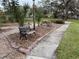 Relaxing common area seating with landscaping and a walking path at 8001 Jasmine Dr # 8001, Temple Terrace, FL 33637