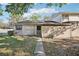 Charming home exterior with a walkway to the front door and a wooden fence creating a private courtyard at 8001 Jasmine Dr # 8001, Temple Terrace, FL 33637