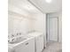 A bright laundry room featuring modern appliances, wire shelving, and a convenient layout at 8001 Jasmine Dr # 8001, Temple Terrace, FL 33637