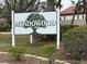 Community signage for Meadowood surrounded by lush landscaping at 8001 Jasmine Dr # 8001, Temple Terrace, FL 33637