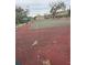 View of the community tennis court with greenery and trees around the perimeter at 8001 Jasmine Dr # 8001, Temple Terrace, FL 33637