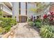 Inviting building entrance surrounded by lush landscaping and a well-maintained walkway at 1001 Pearce Dr # 106, Clearwater, FL 33764