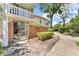 Apartment complex exterior with brick fence, walkway, and landscaping at 1001 Pearce Dr # 106, Clearwater, FL 33764